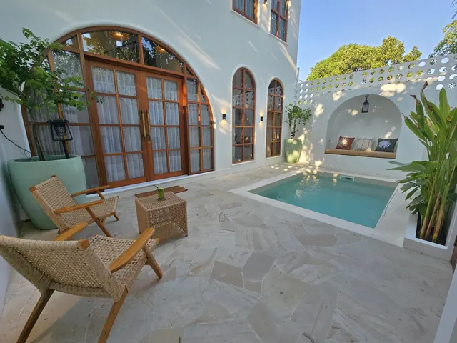 Private villa exterior beside its pool