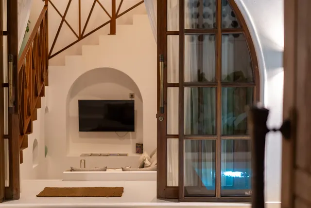 Private villa living area and pool at night