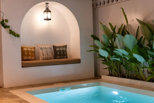 Private villa pool illuminated at night