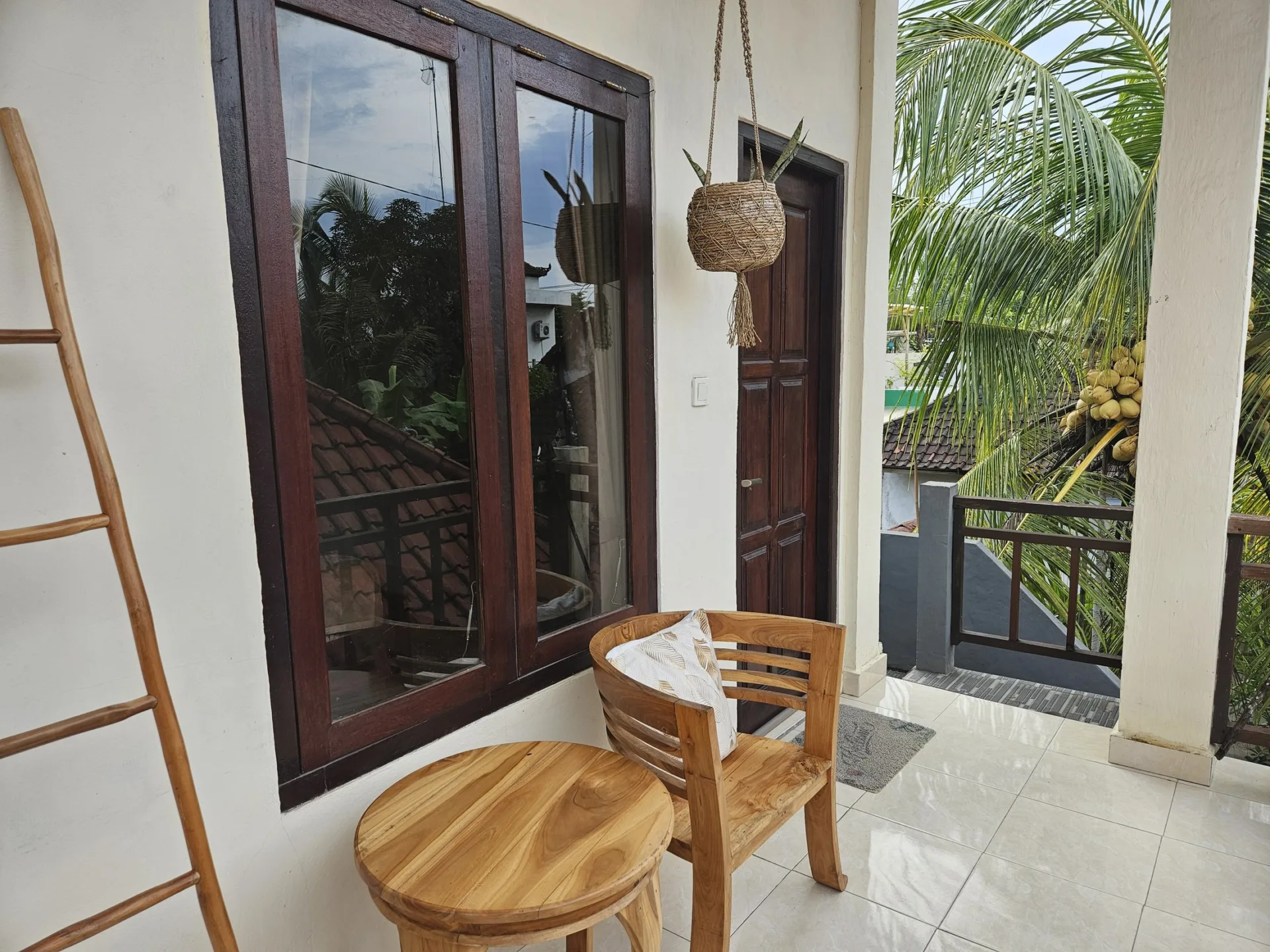 Private balcony seating outside a Risna Homestay room.