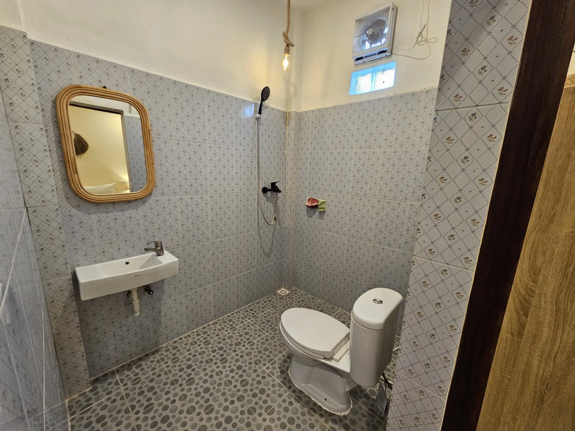 Second view of the private bathroom at Risna Homestay.